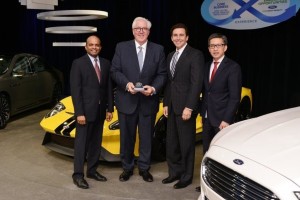 Ford’s Raj Nair, Mark Fields and Hau Tai Tang present Bill Kozyra of TI Automotive (with trophy) with the Ford World Excellence Award for Quality for 2015.